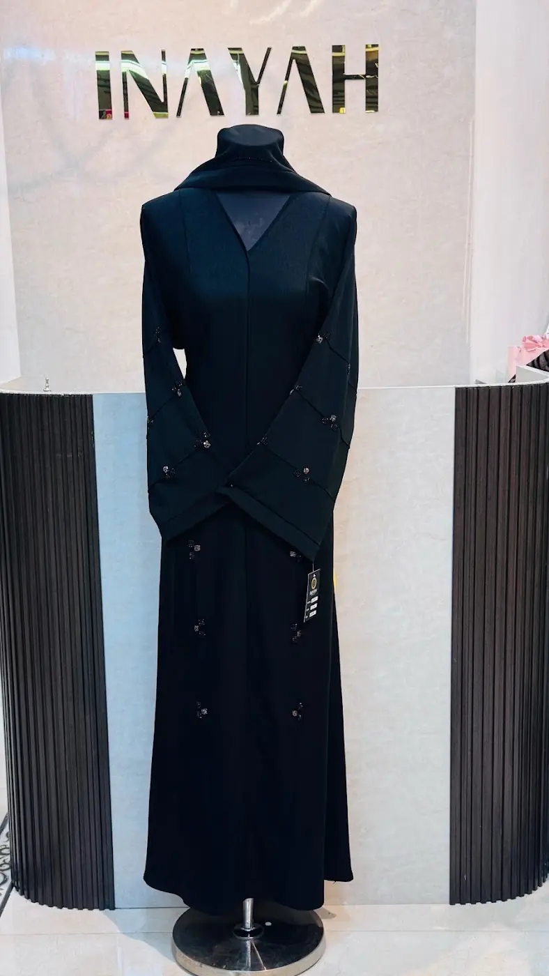 Black abaya with lace sleeves on display at Inayah, Bur Dubai