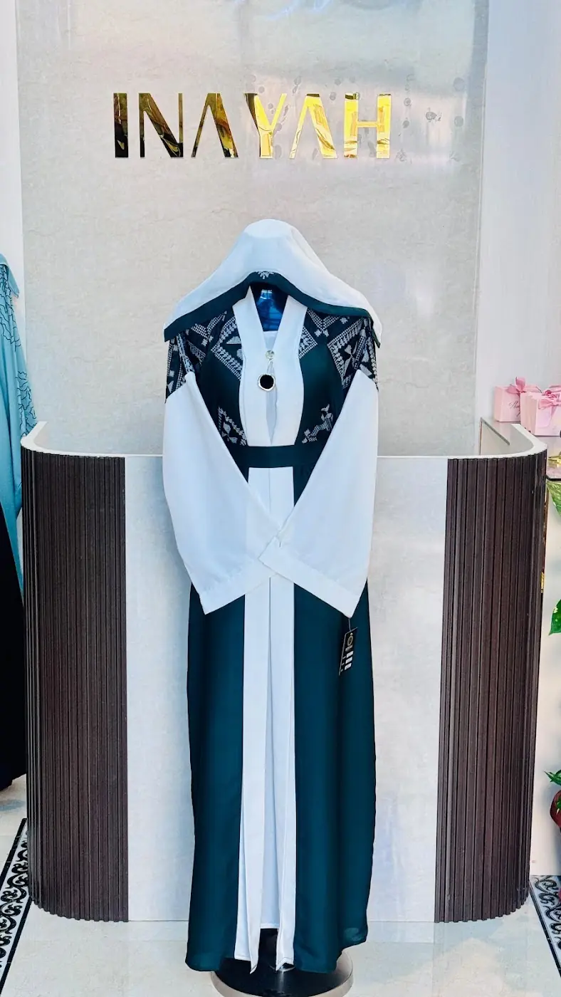 Black and white abaya at Inayah
