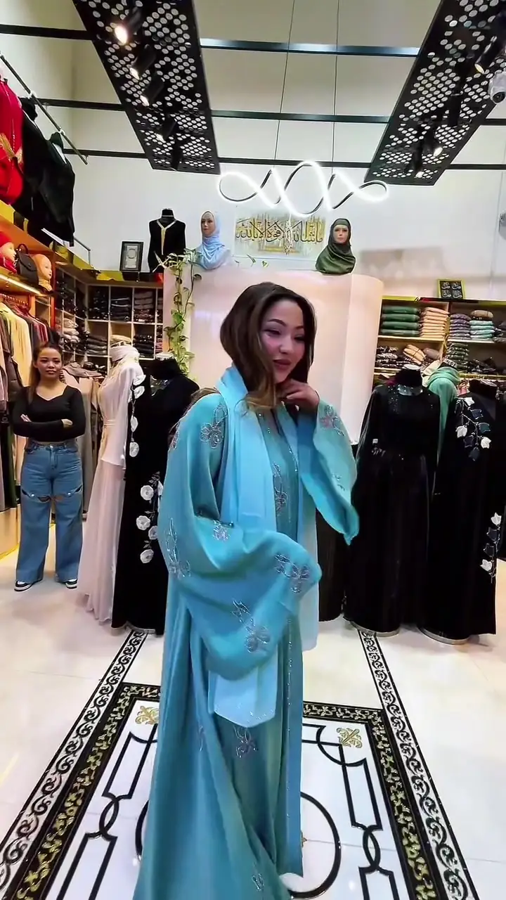 Teal embroidered abaya with matching shayla, inside the Inayah boutique