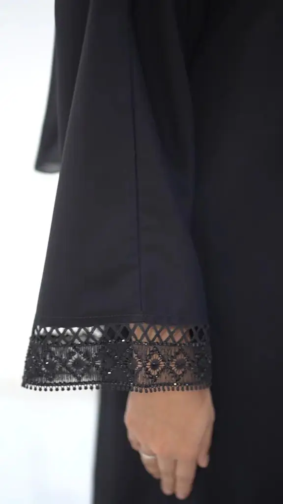 Close-up of lace cuff detail on an Inayah abaya