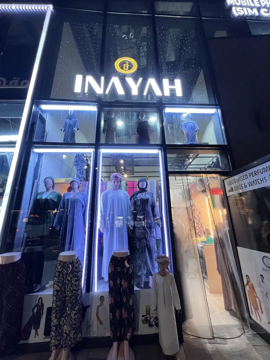 Inayah shopfront at Al Ghubaiba Bus Station, lit at night